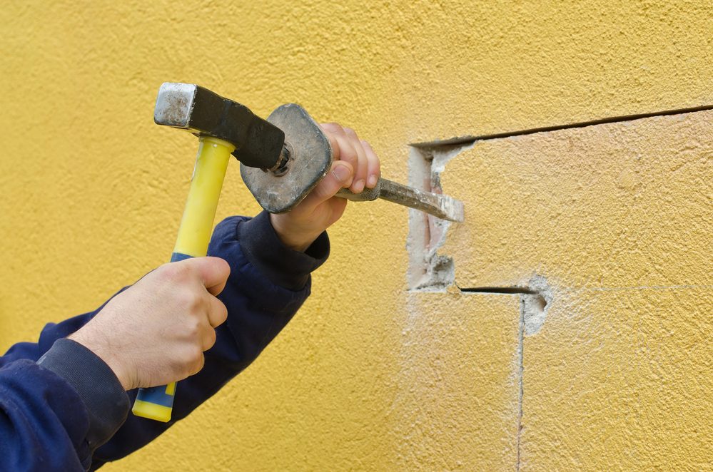 Close-up of stucco wall with crack repair